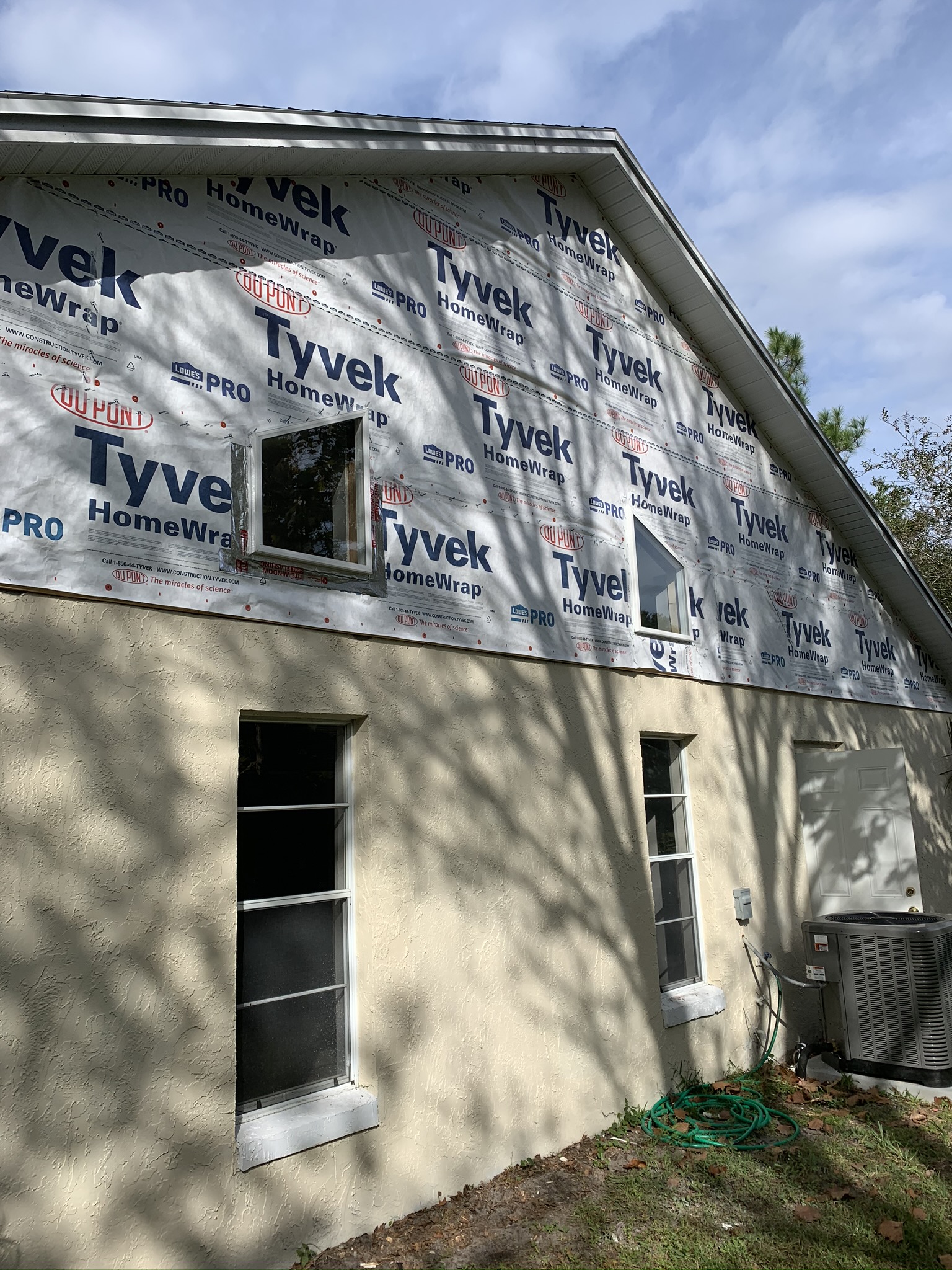 Exterior wall wrapped in house wrap during a Wise Gies Construction renovation