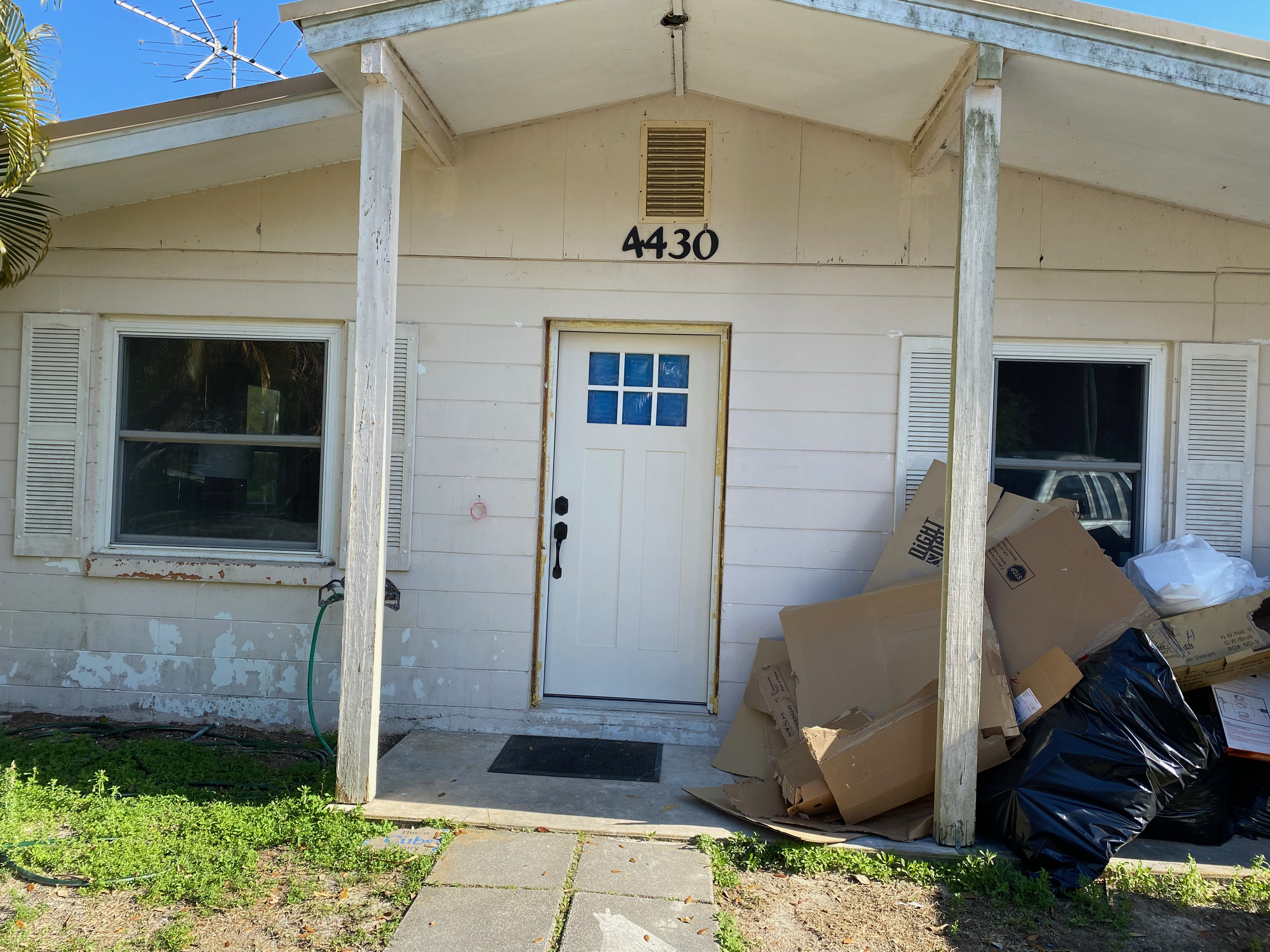 Front porch of a cottage-style home being renovated
