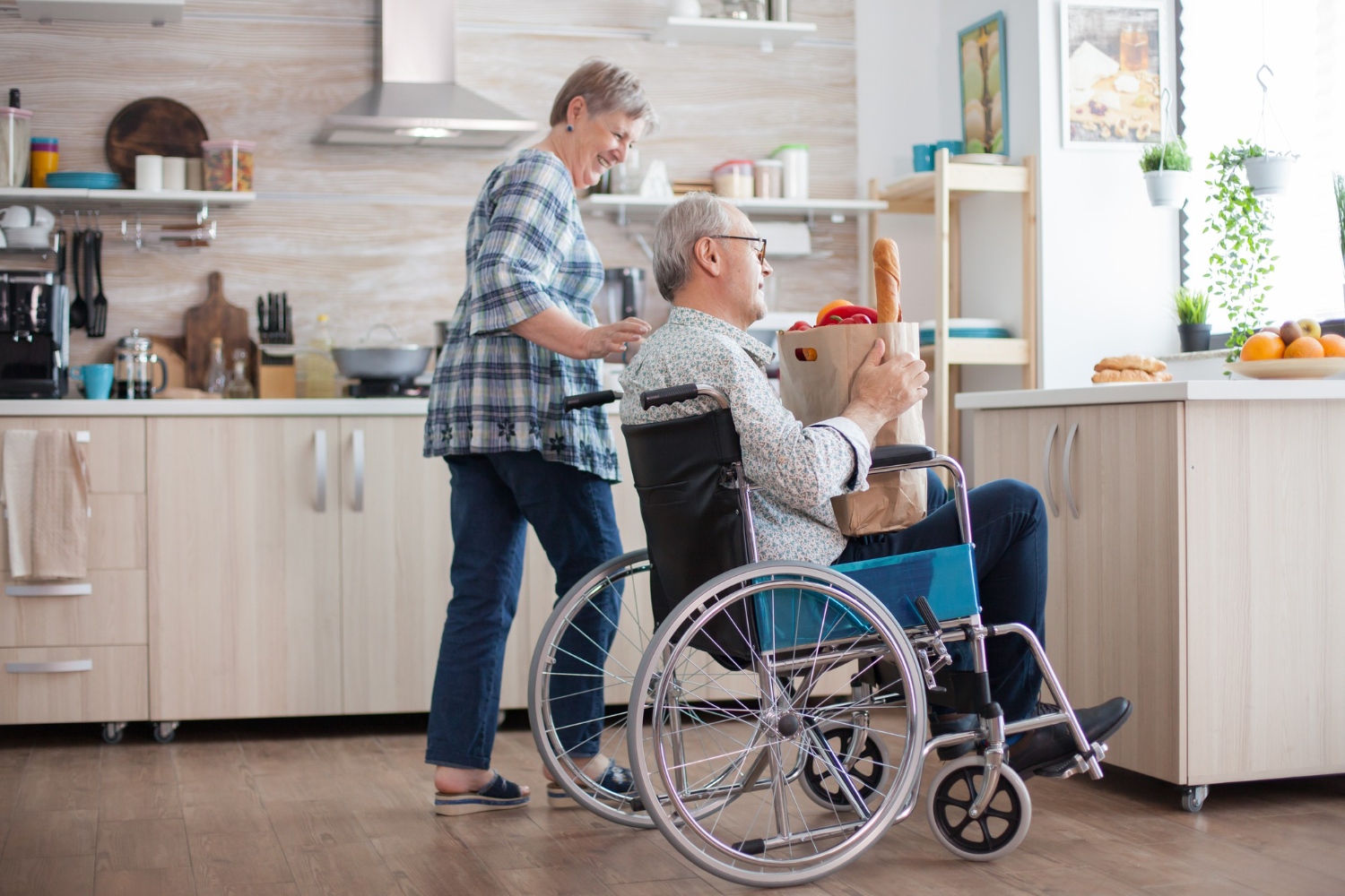 Couple moving easily through an accessible kitchen with a wheelchair