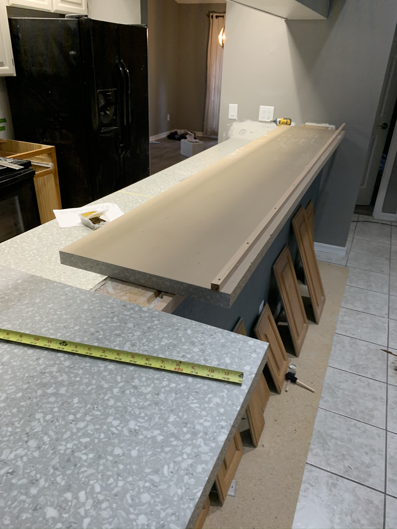 New countertop being set on a kitchen island during installation