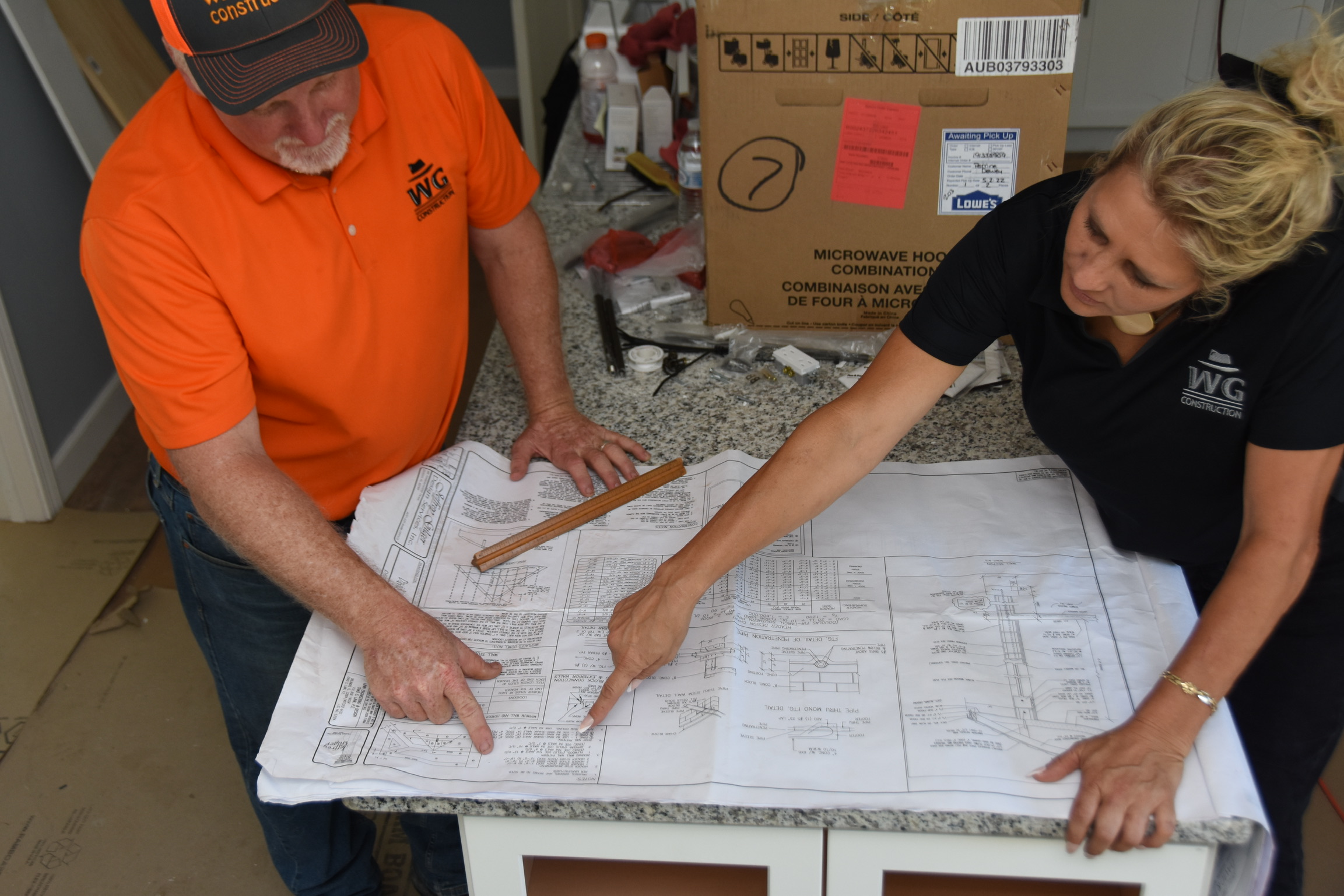 Kurt and Lana Gies reviewing construction plans on site