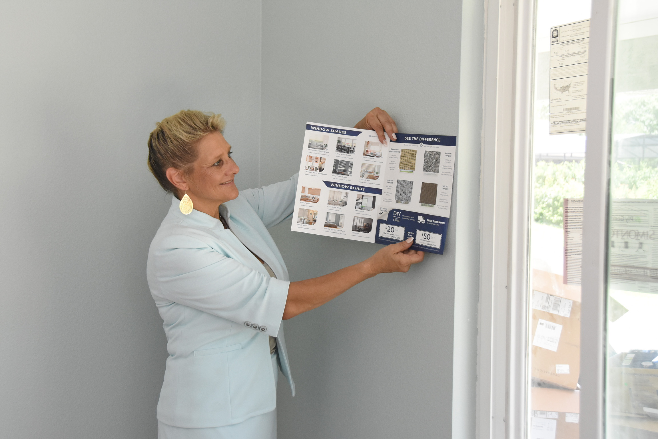 Lana Gies reviewing window shade samples with a client